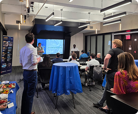 Attendees watching a wastewater technology presentation in a conference room.